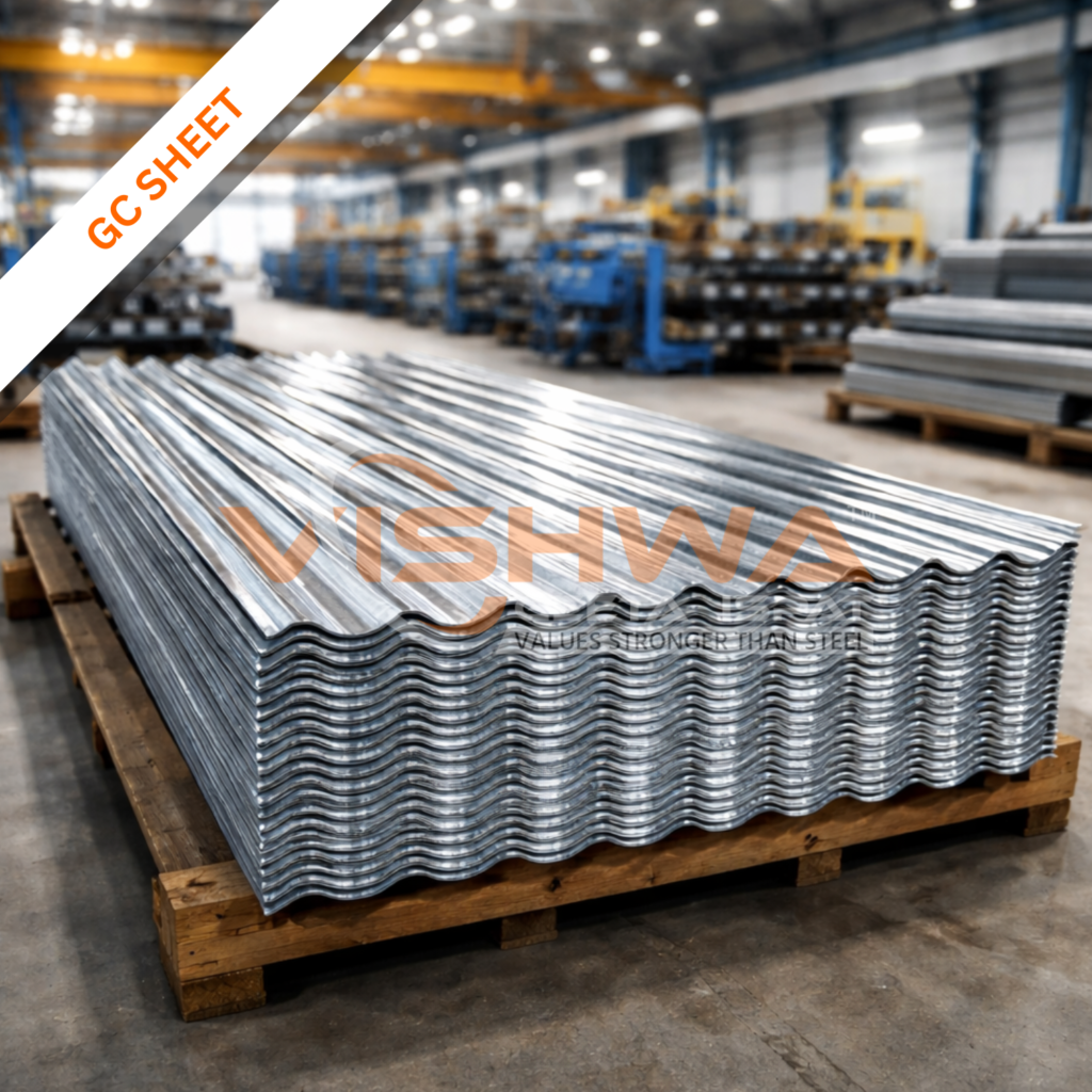 Stack of galvanized corrugated (GC) sheets on a wooden pallet inside a manufacturing center, with industrial machines in the background.